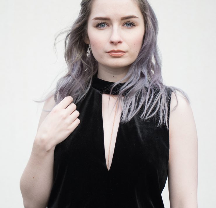 girl wearing black velvet playsuit