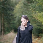 girl standing in forest wearing all black