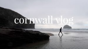 man walking across beach - cornwall vlog