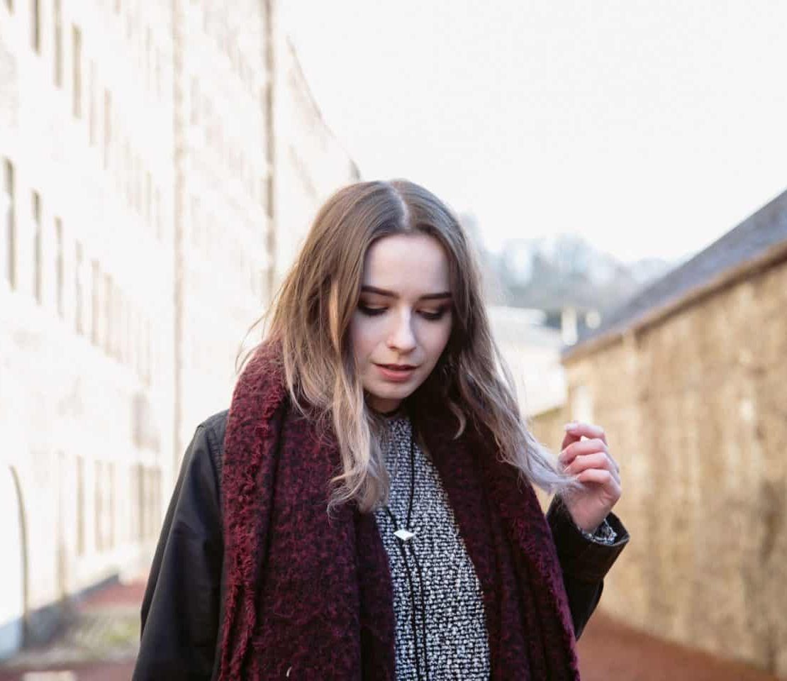 girl stood amongst old buildings in new lanark heritage site