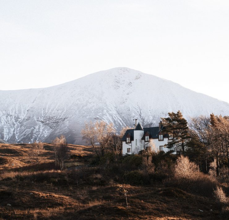 house with turret and mountain in the background in sligachan isle of skye | top 5 rural uk breaks