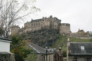 edinburgh castle on top of hill with trees around it