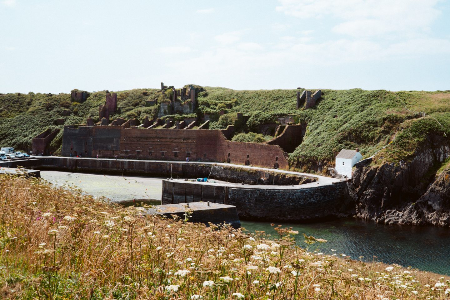 view of porthgain village habour and ruins from the pembrokeshire coastal path