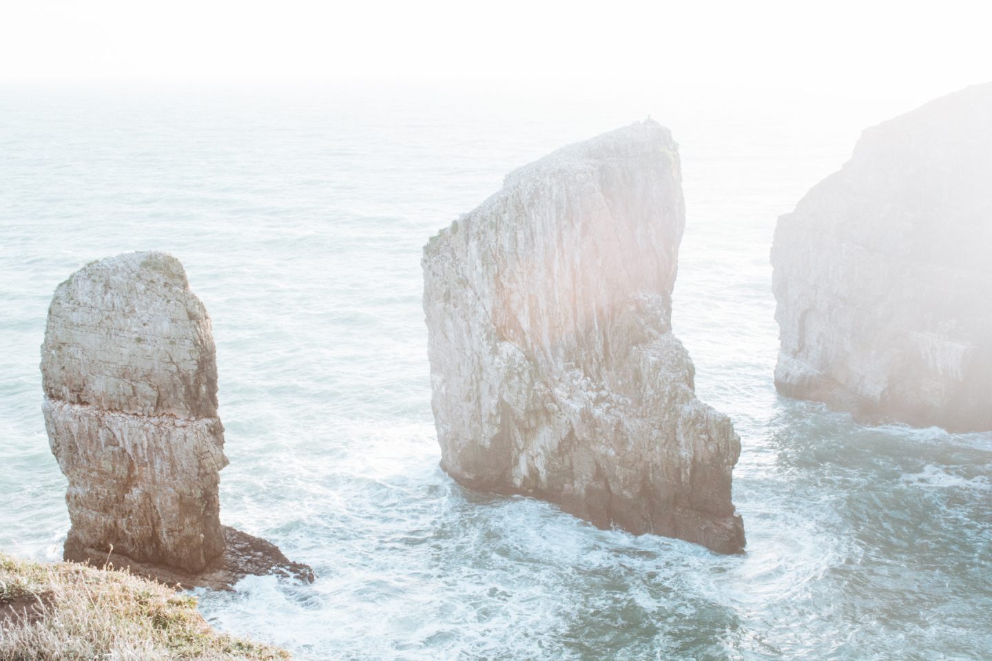 sea stacks on the pembrokeshire coast in hazy sunlight
