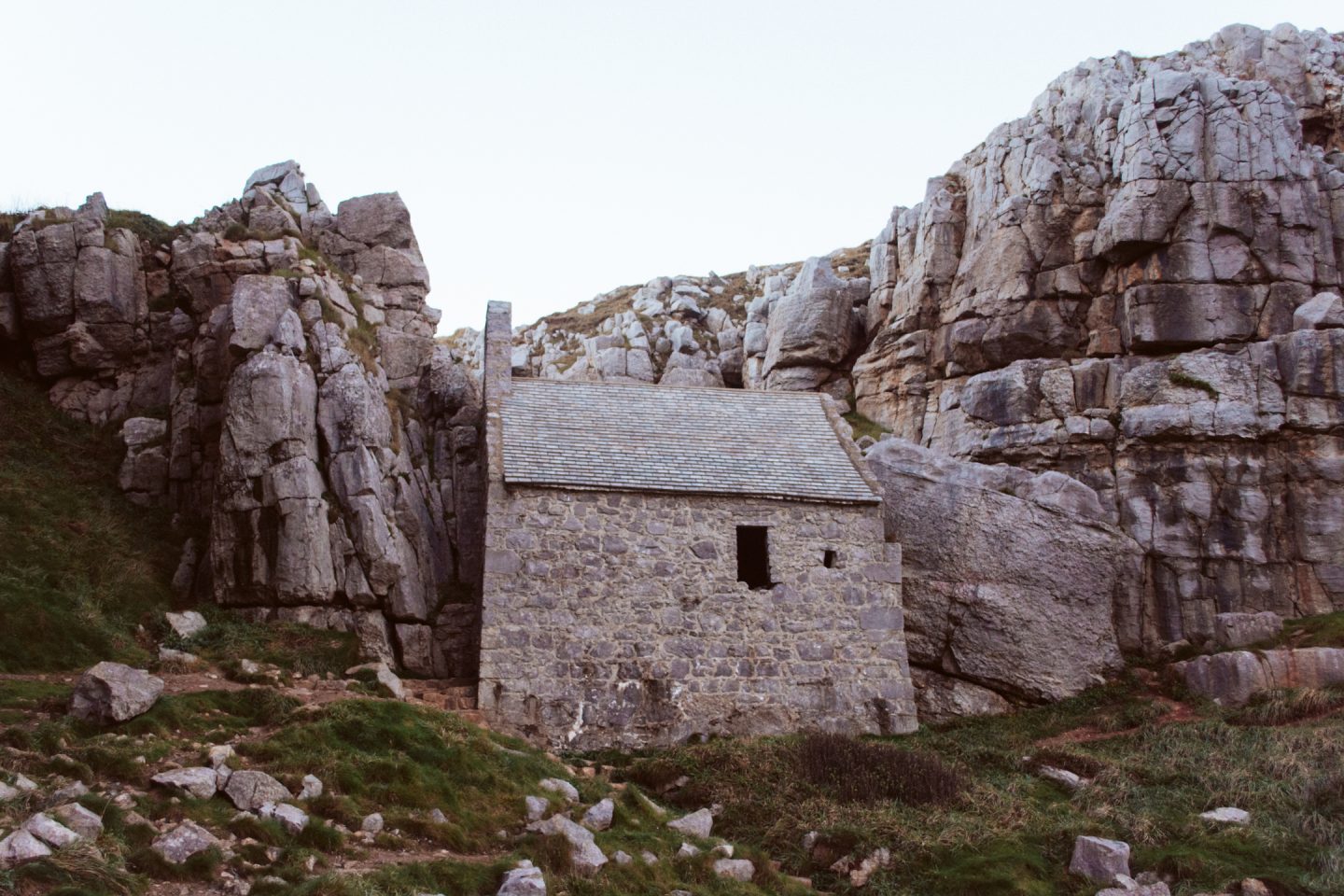 st govan's chapel ruins in the side of a cliff