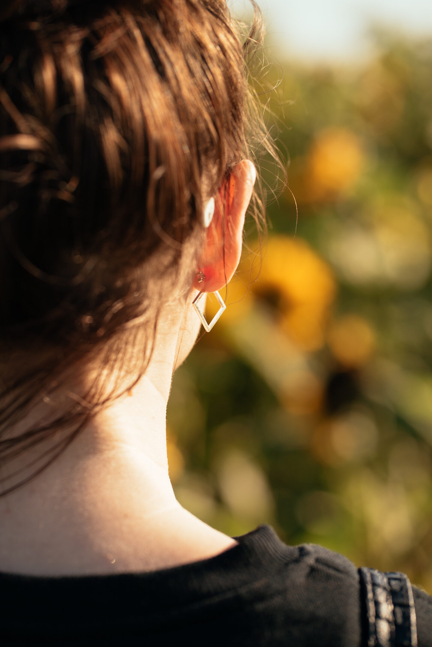 close up of girl wearing silver square hoop earrings from a British ethical jewellery brand Bluebell Lane